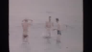 New York USA (1954): Thin Caucasian Appearing Men Are Playing The Water On A Beach