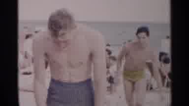 New York USA (1954): Young Boys In Costumes At The Beach Playing Leapfrog