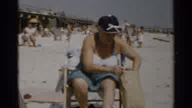 New York USA (1954): Two Women Relaxing On Beach One Digging In Purse Other Lady