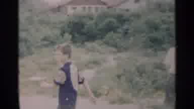 New York USA (1954): Two Boys Walking Through Neighborhood Into Vegetated Area