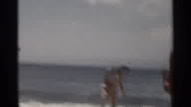 New York USA (1954): People And Child Playing At The Beach And Man Taking Off His