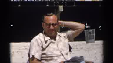 New York USA (1954): Elder Man Wearing Glasses Moving His Hair Back With His Hand