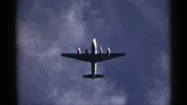 New York USA (1954): An Aircraft Flying Over Two Men At The Beach