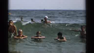 New York USA (1954): People Swimming In The Ocean And Playing In The Waves