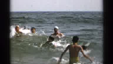 New York USA (1954): People Bathing And Playing With Wave In The Ocean