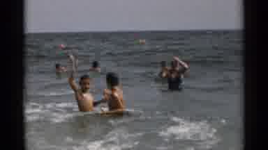 New York USA (1954): Groups Of People Swimming And Playing In The Medium Waves Of
