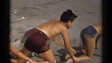 New York USA (1954): Four Boys In Swimsuits Crawl In Sand On Ocean Shoreline