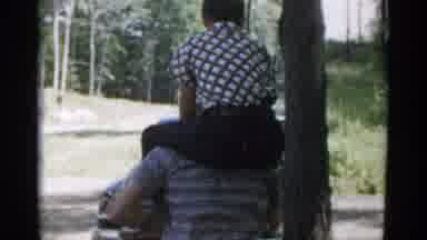 New York USA (1954): A Guy Sitting On Someone's Shoulders They Are Walking Along