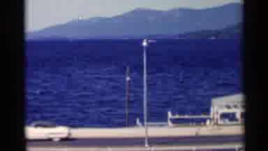 Lake George New York (1955): Over A River Between Mountains People Walk On The
