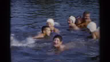 Lake George New York (1955): A Group Of People Swim In A Large Lake Some Wear Swim