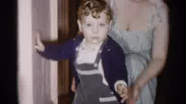 New York City (1955): Woman Wearing Checked Dress Picks Up Toddler With Curly Hair