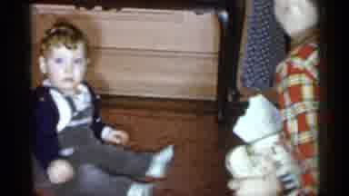 New York City (1955): Baby Sits On Floor Then Is Held By Older Sibling