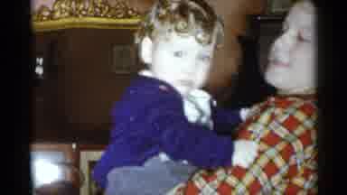 New York City (1955): A Baby Being Held By It Mom In There House