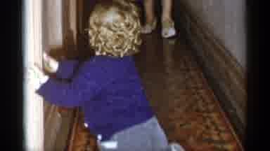 New York City (1955): Kid Holding On To Walls As It Tries To Walk While Mom