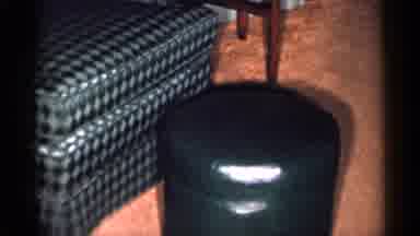 New York City (1955): Camera Pans Over Green Checkered Chair Green Leather Ottoman