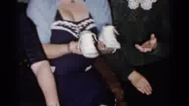 New York City (1955): Some Very Small White Shoes Being Gifted Form One Person To