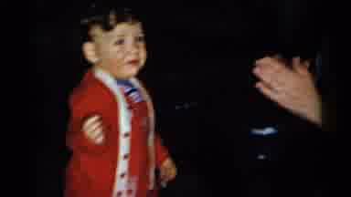 New York City (1955): Toddler Wearing Red Overalls And Red Jacket Playing With