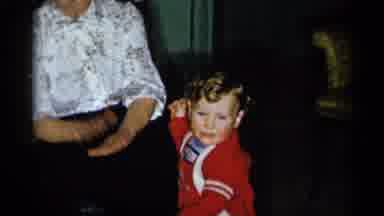 New York City (1955): Woman Wearing White Shirt Claps Hands For Baby Wearing Red