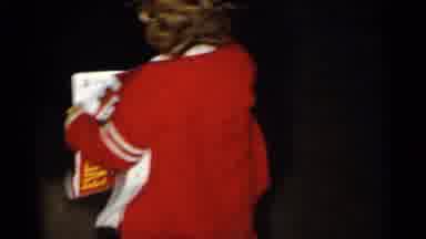 New York City (1955): A Young Child With Red Clothes Smiling With An Advertising