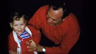New York City (1955): Man And Baby Both Dressed In Red Smiling For The Camera
