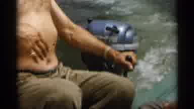 Cape Cod Massachusetts (1956): Man Wearing Red Hat Operates Outboard Boat Motor On