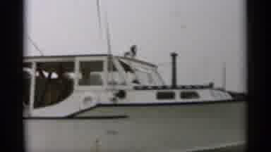 Cape Cod Massachusetts (1956): A White Boat That Is Zooming Along With People In