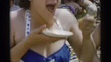 Jones Beach New York (1956): Woman Wearing Red Cap Competes In Eating Contest On A