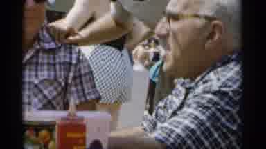 Jones Beach New York (1956): Man Wearing Blue Shirt And Glasses Eating At Picnic