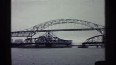 Duluth Minnesota (1960): River With Super Long Iron Bridge Under Cloudy Sky