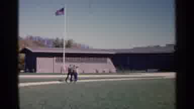 Sioux Falls South Dakota (1960): A Group Of Young Men Walk Past An American Flag