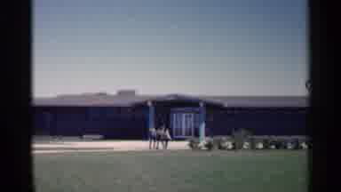 Sioux Falls South Dakota (1960): Three People Walking Outside Towards Building The