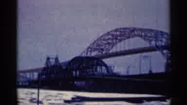 Duluth Minnesota (1961): River With Far Iron Bridge Among The Sky Seen From Below