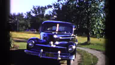 Duluth Minnesota (1961): Men Wearing Black Pants Stand In Front Of Black Car On A