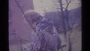 SPAIN-1961: A Person In A Patterned Jacket Walking Through A Farmstead