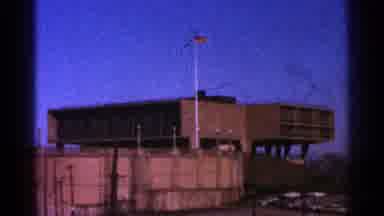 Milwaukee Wisconsin-1964: American Flag Flying Next To Brown Building On A Clear Day