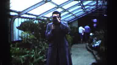 Minnesota USA (1964): A Man Takes The Photography Of A Flower Park And Waterfall