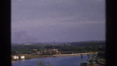 Minnesota USA (1964): A Shot Of A River Bend With A City In The Background During