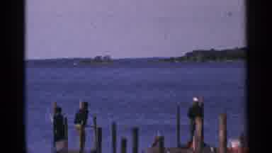 Minnesota USA (1964): People Standing On A Pier Looking Out Into A Body Of Water
