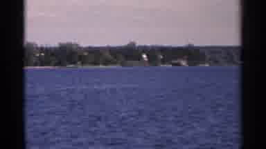 Minnesota USA (1964): Trees Surround Homes That Line The Riverbanks Of A Blue