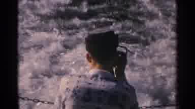 Minnesota USA (1964): A Man Stands On A Boat Looking At The Water The Boat Is