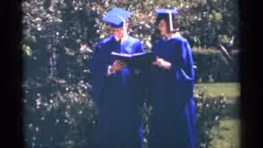 Minnesota USA (1964): A Man And Woman In Blue Caps And Gowns Stand In Front Of