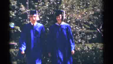 Minnesota USA (1964): Two People Walking During Graduation Wearing Their Blue
