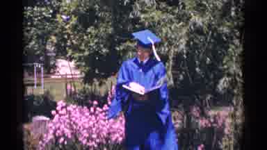 Minnesota USA (1964): Young Man In Blue Graduation Cap And Gown Reading A Book In