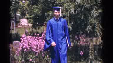 Minnesota USA (1964): A Man Walking Towards The Camera In His Blue Graduation Cap