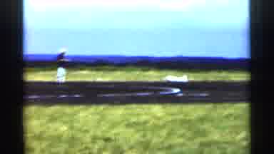 Minnesota USA (1964): Model Airplane Landing Near Man In Open Minnesota USA Field