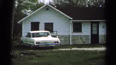 Washington Island Wisconsin (1964): White Car Parked In Front Of A White House On