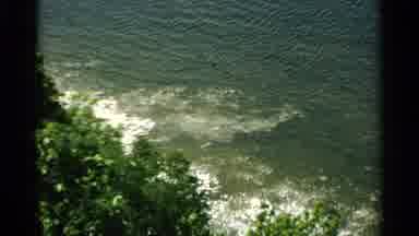 Washington Island Wisconsin (1964): Waves Crash On A Rocky Bank While People Are