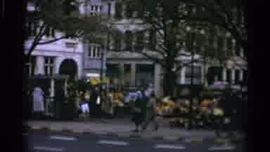 Copenhagen Denmark (1965): People Walking And Cars Driving Past An Outdoor Market