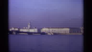 LENNINGRAD RUSSIA-1965: Pan Shot Showing Large Buildings and a Lighthouse by the Waterfront