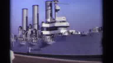 LENNINGRAD RUSSIA-1965: People Standing Next To A Docked Military Ship On A